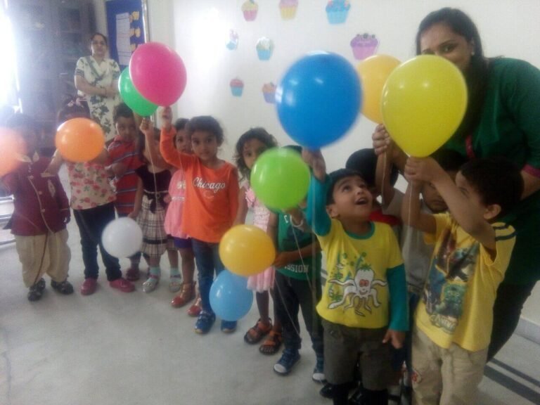 Students participating in Balloon Day celebration at Lovedale International School, Hyderabad, Banjara Hills, surrounded by colorful balloons and festive atmosphere.